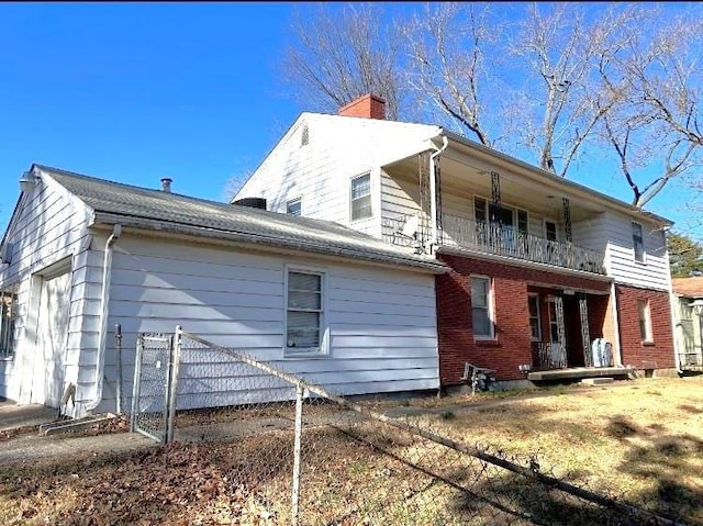 back of house featuring a balcony