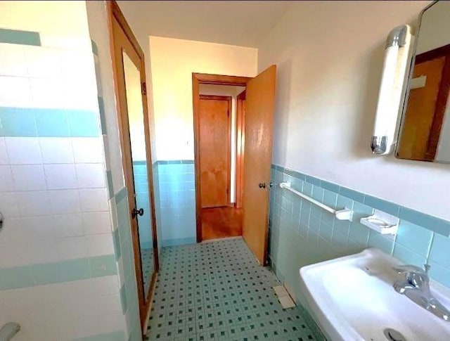 bathroom with tile walls