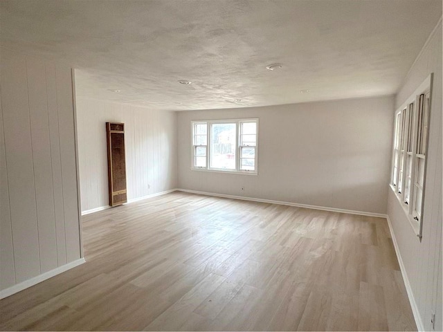 unfurnished room with light hardwood / wood-style floors