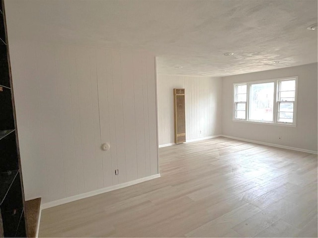 empty room with light hardwood / wood-style floors