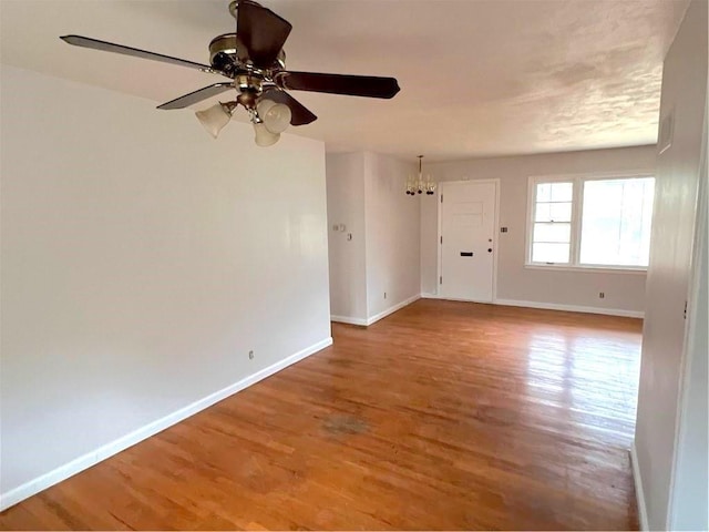 empty room with hardwood / wood-style floors and ceiling fan