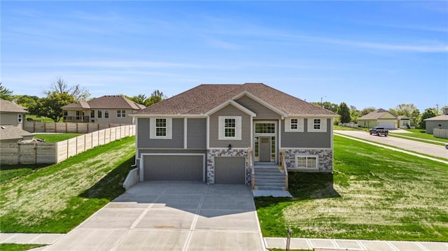 12414 Adam St, Excelsior Springs, MO 64024 - view of front of house featuring a garage, driveway, and stone siding