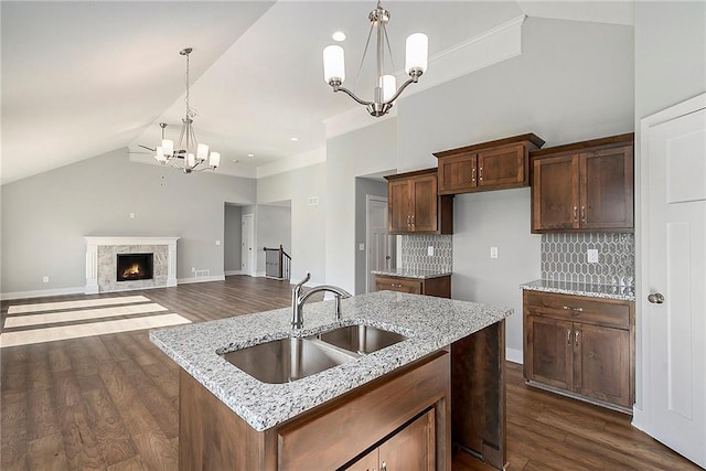 12414 Adam St, Excelsior Springs, MO 64024 - kitchen with a sink, a chandelier, lofted ceiling, dark wood finished floors, and decorative light fixtures