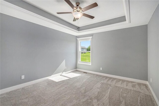12414 Adam St, Excelsior Springs, MO 64024 - carpeted empty room featuring baseboards, a ceiling fan, and a raised ceiling