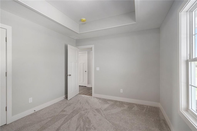 12414 Adam St, Excelsior Springs, MO 64024 - carpeted spare room with plenty of natural light, baseboards, and a tray ceiling