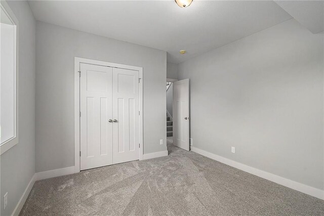 12414 Adam St, Excelsior Springs, MO 64024 - unfurnished bedroom featuring carpet flooring, a closet, and baseboards