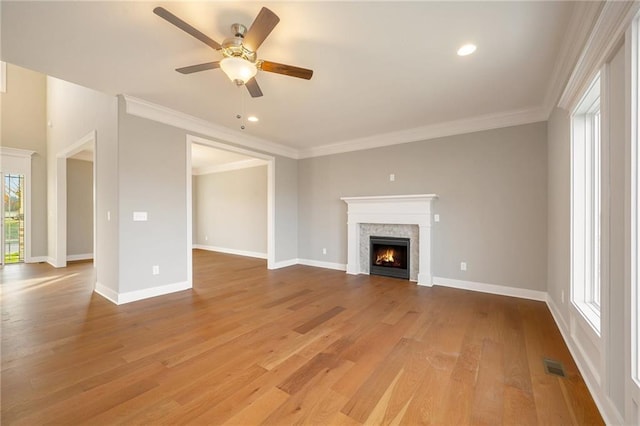 unfurnished living room with ornamental molding, light hardwood / wood-style flooring, and ceiling fan