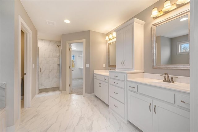 bathroom featuring vanity and tiled shower