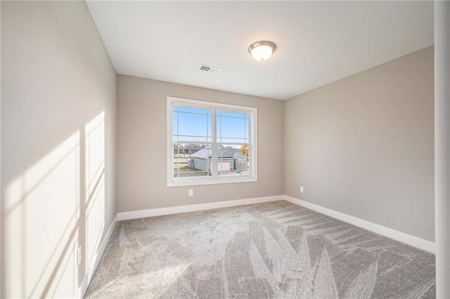 unfurnished room featuring light carpet