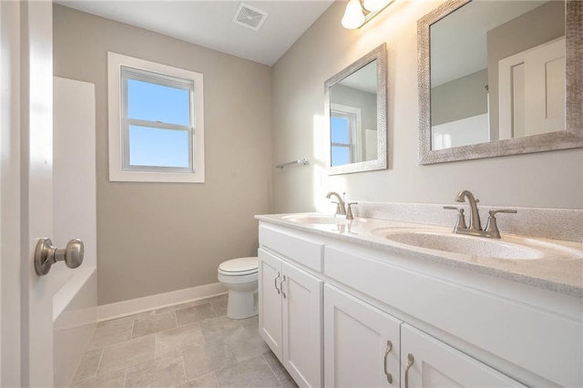 bathroom featuring toilet and vanity