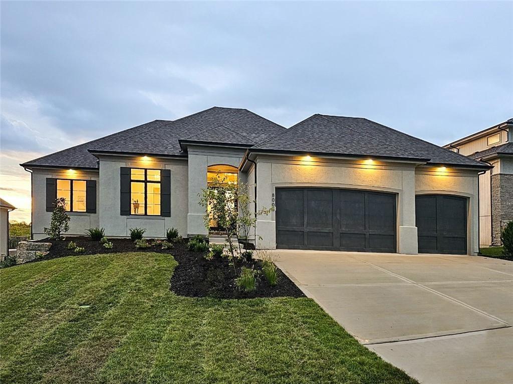 view of front of property with a garage and a front yard