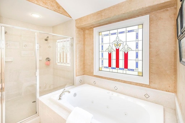 bathroom with a jetted tub, a shower stall, and a wealth of natural light