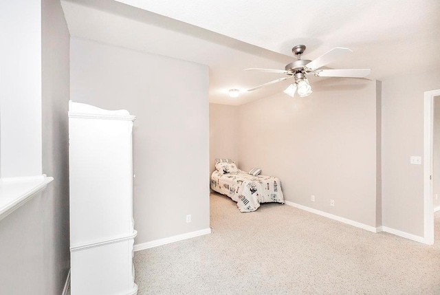 unfurnished bedroom with ceiling fan and baseboards