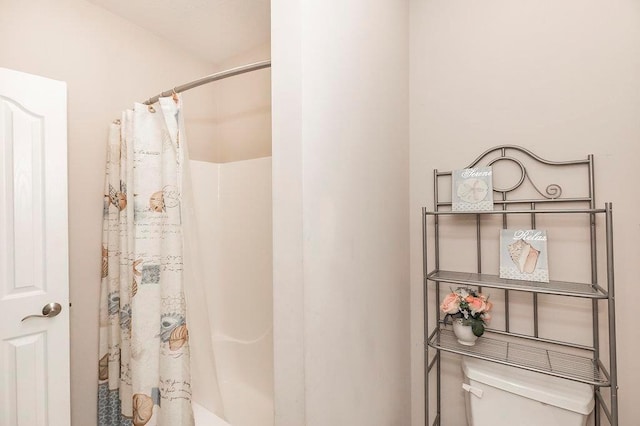 full bathroom featuring shower / tub combo and toilet