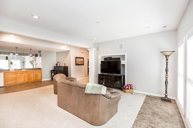 living room featuring decorative columns, visible vents, baseboards, and recessed lighting