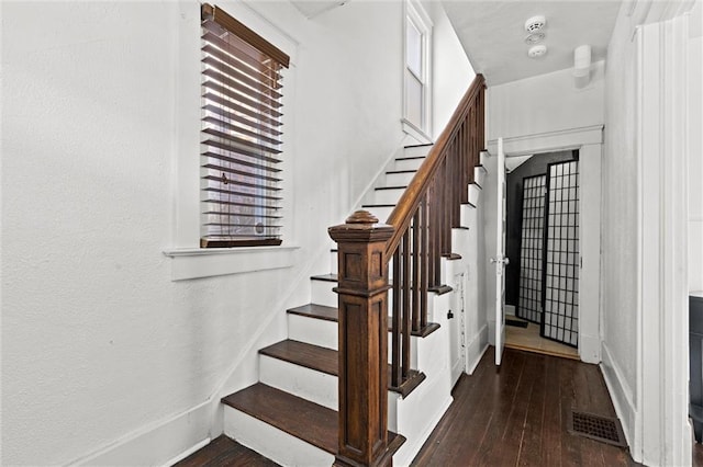 staircase with hardwood / wood-style flooring