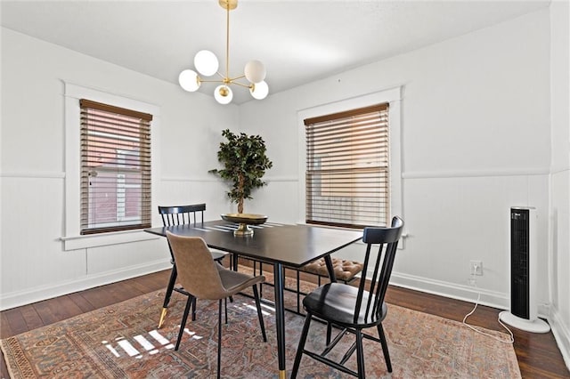 dining space with a notable chandelier and hardwood / wood-style floors