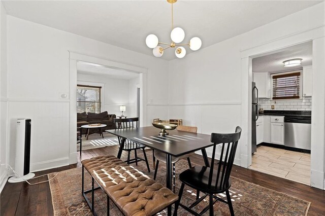 dining area featuring a chandelier and wood-type flooring