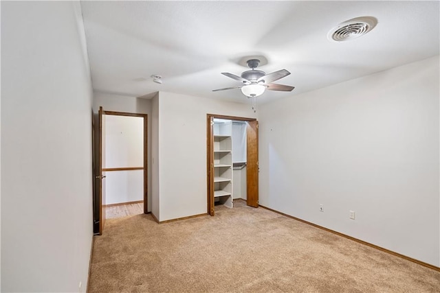 unfurnished bedroom featuring a ceiling fan, visible vents, light carpet, and baseboards