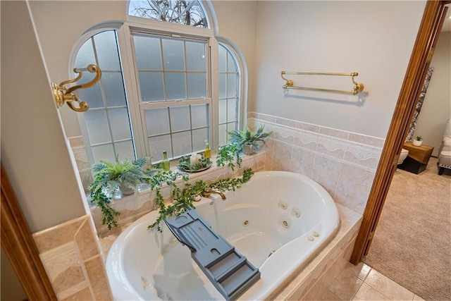 full bath featuring a jetted tub and tile patterned floors