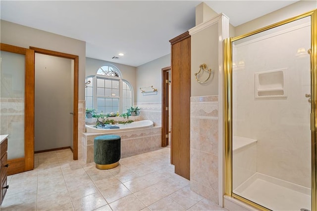 bathroom with a garden tub, visible vents, vanity, a shower stall, and tile patterned floors