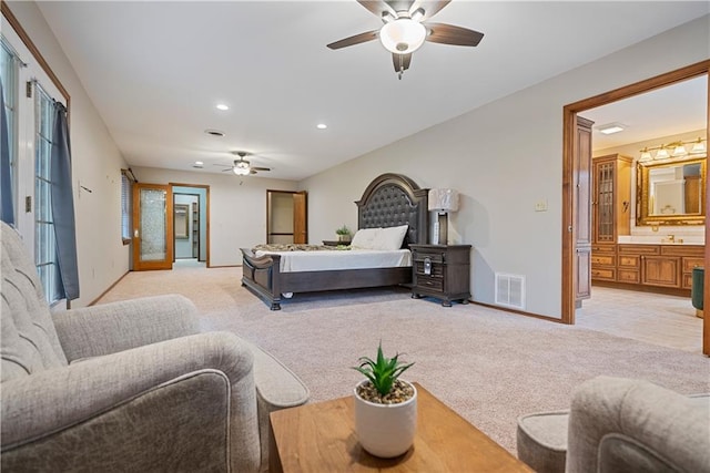 bedroom featuring recessed lighting, visible vents, light carpet, connected bathroom, and baseboards