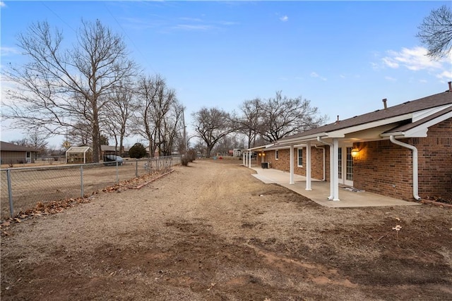 view of yard featuring fence and a patio