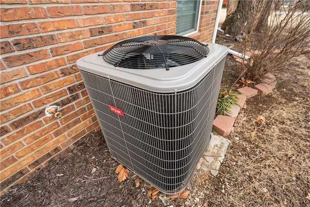 details featuring brick siding and central AC unit