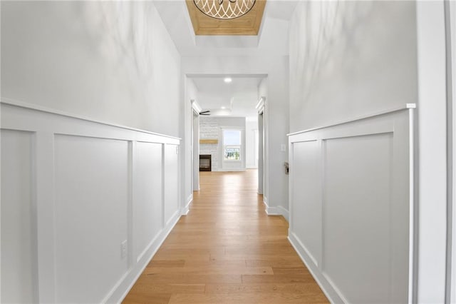 17151 W 168th Pl, Olathe, KS 66062 - corridor featuring a decorative wall, light wood finished floors, a chandelier, and a wainscoted wall