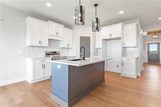 17151 W 168th Pl, Olathe, KS 66062 - kitchen featuring stainless steel range with electric stovetop, recessed lighting, white cabinetry, tasteful backsplash, and light wood-type flooring