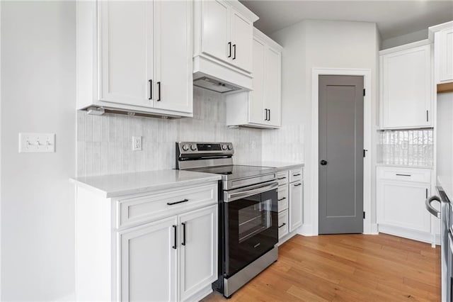 17151 W 168th Pl, Olathe, KS 66062 - kitchen with stainless steel electric range, custom range hood, backsplash, and white cabinetry