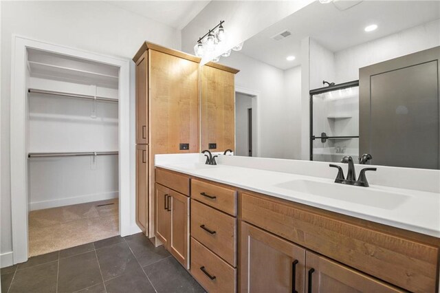 17151 W 168th Pl, Olathe, KS 66062 - bathroom featuring double vanity, tile patterned flooring, and a spacious closet