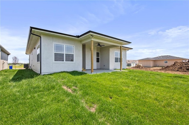 17151 W 168th Pl, Olathe, KS 66062 - back of house with ceiling fan, a patio, a yard, and stucco siding
