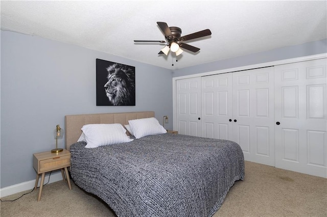 carpeted bedroom featuring a closet and ceiling fan