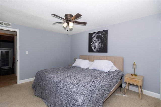 bedroom featuring ceiling fan and light carpet