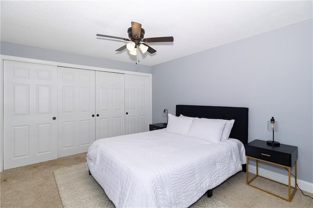 bedroom with light carpet, a closet, and ceiling fan