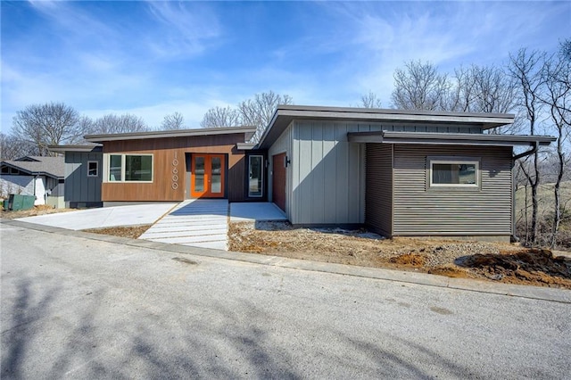 view of front of house with concrete driveway and french doors