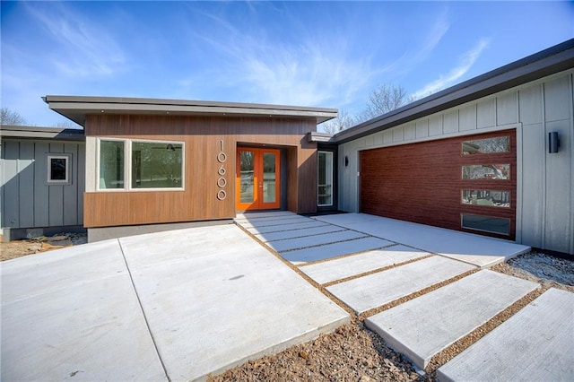 modern home with a garage, board and batten siding, and concrete driveway