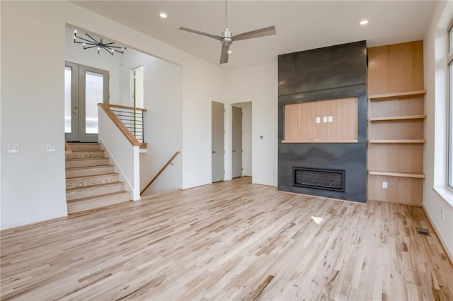 unfurnished living room featuring visible vents, ceiling fan, recessed lighting, a fireplace, and wood finished floors