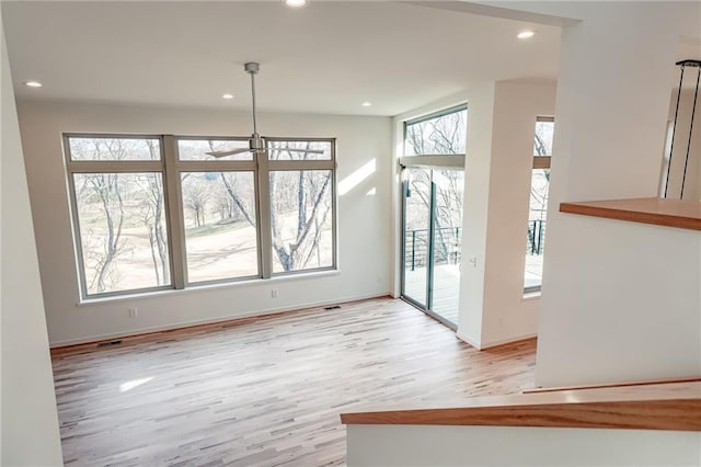 unfurnished dining area featuring recessed lighting and a healthy amount of sunlight