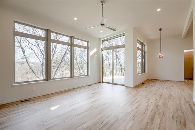 interior space featuring baseboards, visible vents, recessed lighting, ceiling fan with notable chandelier, and light wood-type flooring