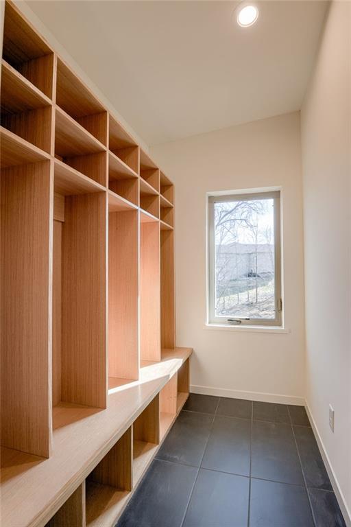 mudroom featuring recessed lighting, baseboards, and dark tile patterned flooring