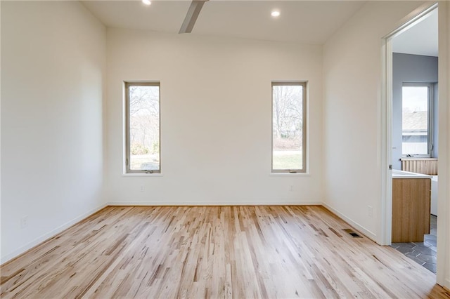 empty room featuring recessed lighting, visible vents, baseboards, and light wood-style floors