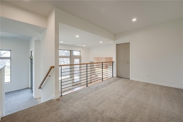 carpeted spare room with a wealth of natural light, baseboards, and recessed lighting