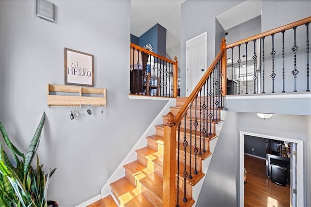 stairs featuring baseboards and wood finished floors