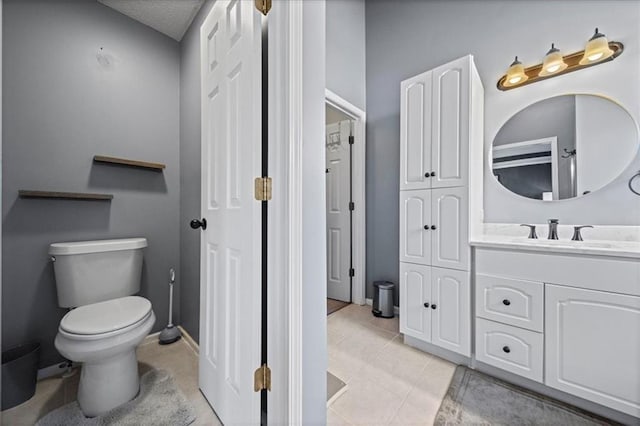 bathroom featuring vanity, toilet, and tile patterned floors