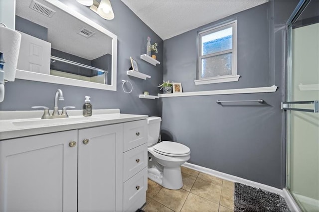 bathroom featuring a textured ceiling, toilet, visible vents, vanity, and tile patterned floors