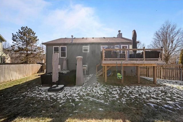 rear view of property featuring a fenced backyard, stairway, and a deck