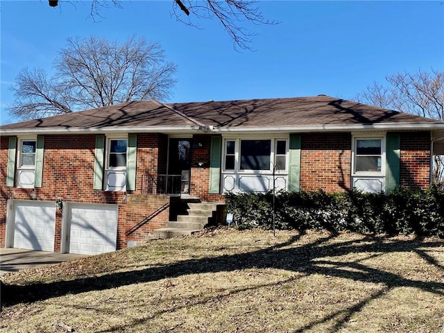 view of front of property with driveway, brick siding, and an attached garage