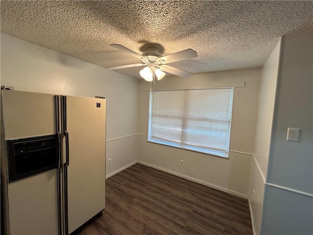 kitchen featuring ceiling fan, white fridge with ice dispenser, dark hardwood / wood-style floors, and a textured ceiling